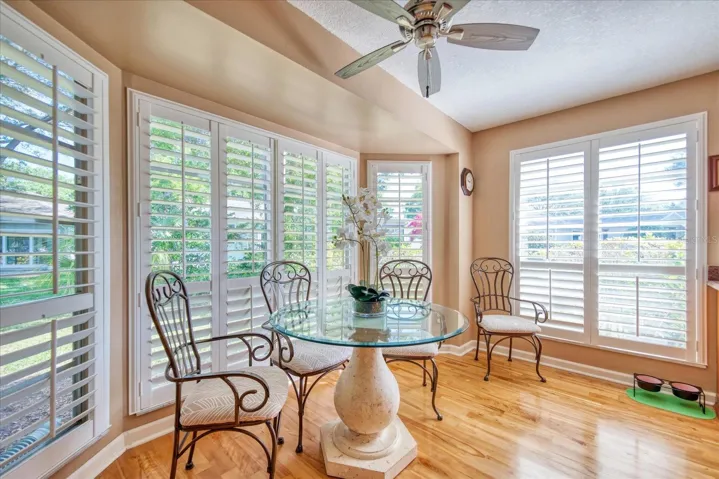 kitchen dining surrounded by windows with plantation shutters~