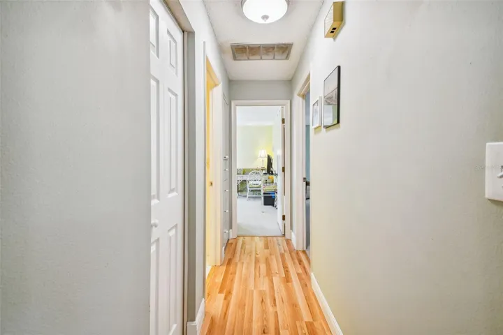 standing in living room, looking down the hall towards the bedrooms