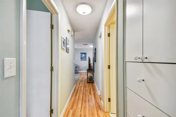 standing in 2nd bedroom, looking down the hall towards the living room