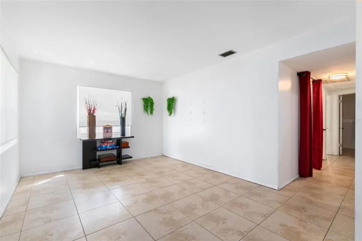 Step into the large living room, filled with natural light, creating a warm and inviting atmosphere.
