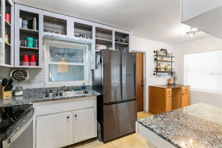 Enjoy a peaceful view of the screened lanai from the kitchen sink.