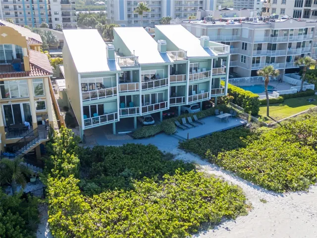 Community deck overlooking the glittering blue waters of the Gulf of Mexico and steps to the beach.