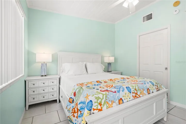 Large bedroom with exit to the backyard patio and community laundry room. (Exit to the left, next to the window)