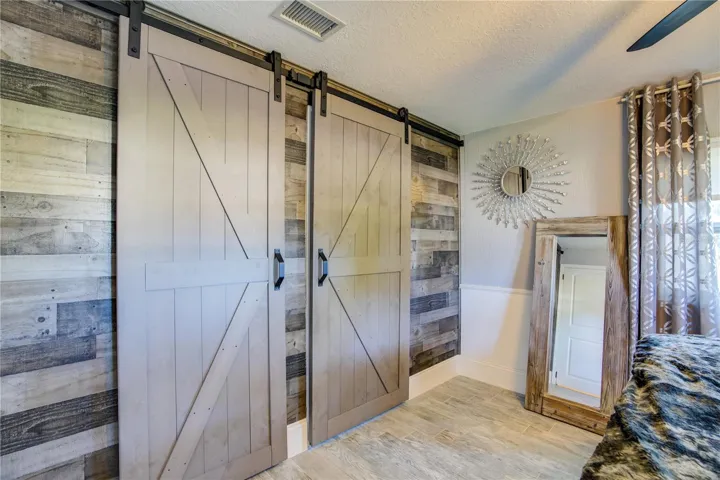 The reclaimed wood and custom barn doors provide a great accent wall in the Master Bedroom. Behind the barn doors are a walk-in closet and Master Bath