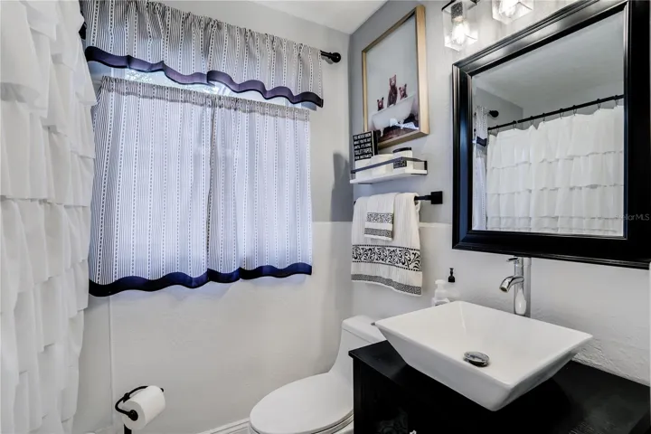 Bath #2 also features a custom, furniture style vanity and designer sink