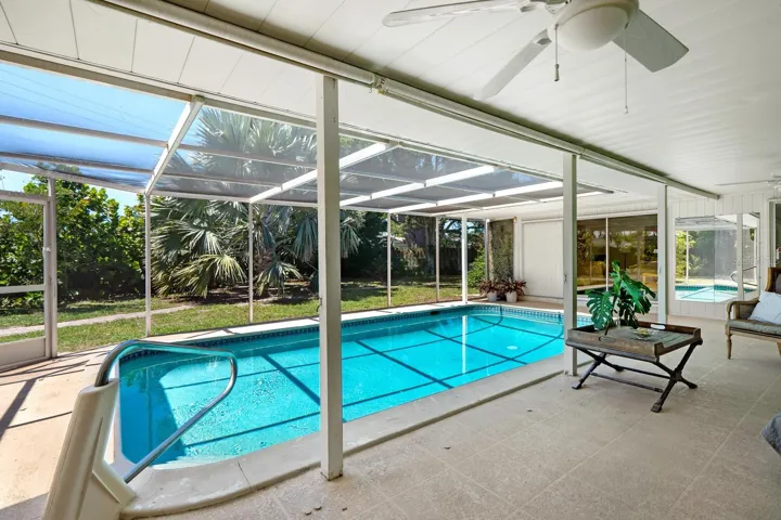 Caged Pool and Backyard w/ Bismarck Palm