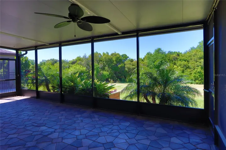Covered outdoor patio with caged lanai.