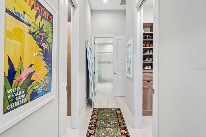Separate spacious walk-in closets on each side with custom shelving