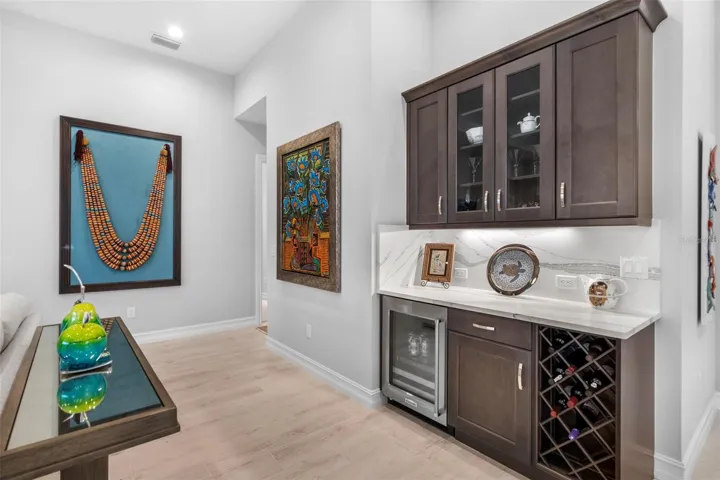 Dry bar with wine/beverage cooler and addt'l wine storage