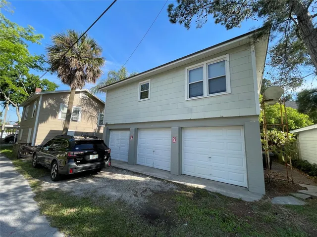 Three car garage with 1/1 above