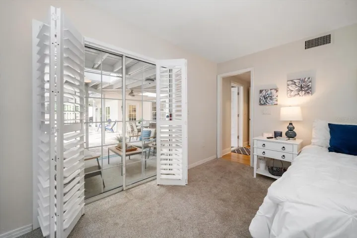 Primary bedroom with sliders leading to the pool area!