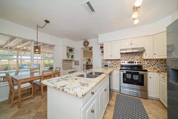 The kitchen overlooks the pool and enters to the family room!