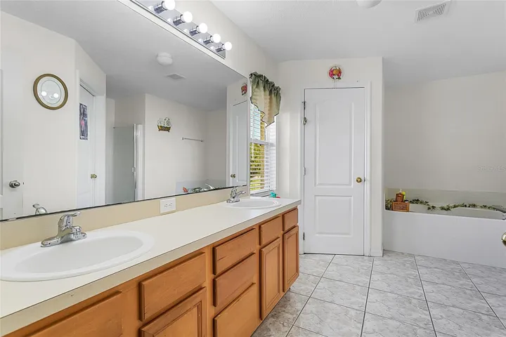 Ensuite primary bath includes beautiful garden tub and separate shower