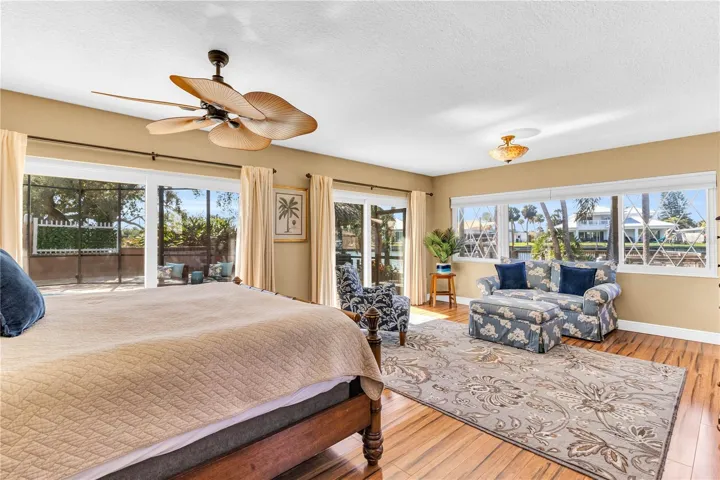 Master bedroom suite with bay window and two large panel impact resistant sliders that open up into the pool area.