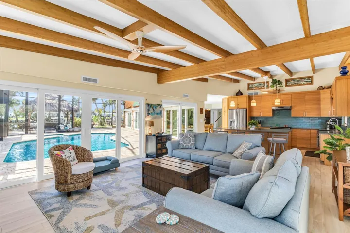 Formal living or family with two sets of impact sliders into the pool deck and backyard.