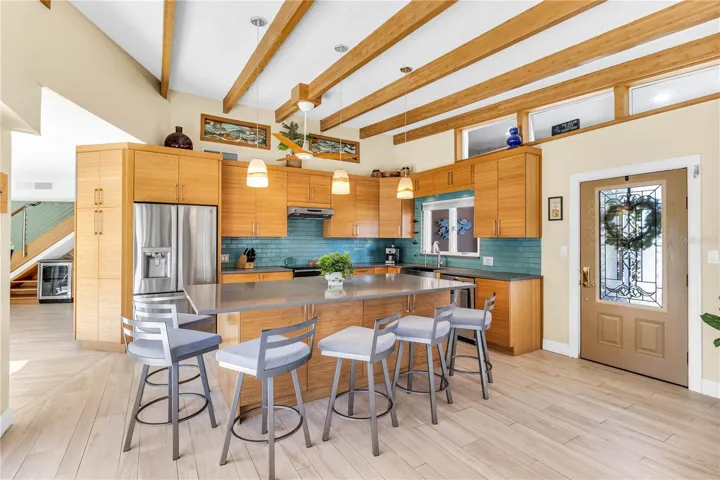 Custom designed open concept kitchen with solid bamboo cabinets, pull out drawers, stainless steel appliances, island and more.