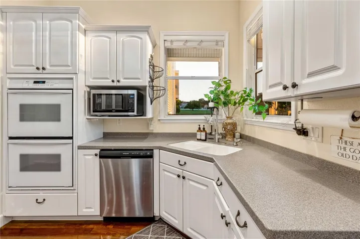 Kitchen with Corian Counters, Custom Cabinets, Gas Cooktop and Double Oven