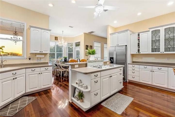 Kitchen with Corian Counters, Custom Cabinets, Gas Cooktop and Double Oven