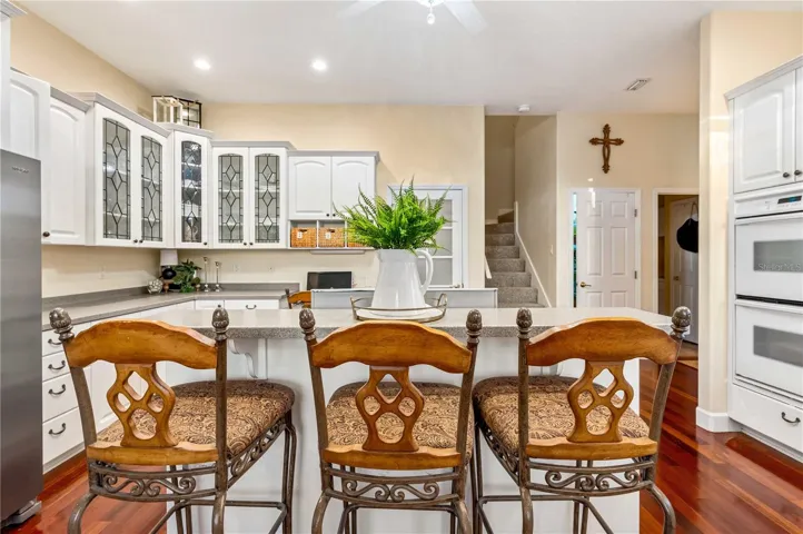 Kitchen with Corian Counters, Custom Cabinets, Gas Cooktop and Double Oven