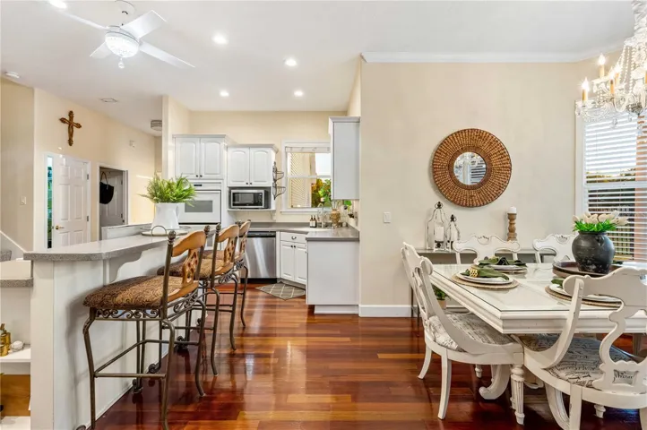 Kitchen with Corian Counters, Custom Cabinets, Gas Cooktop and Double Oven