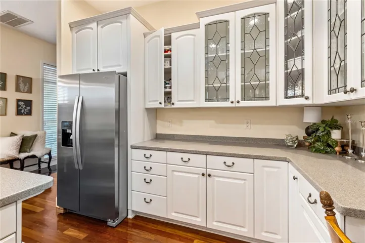 Kitchen with Corian Counters, Custom Cabinets, Gas Cooktop and Double Oven