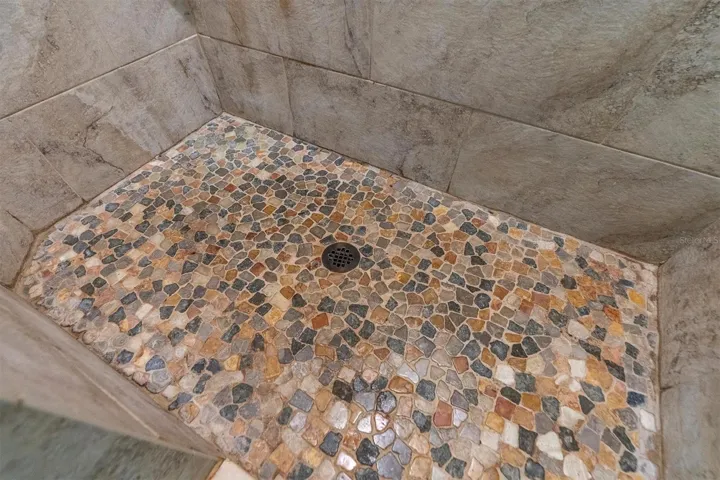 River rock in master shower