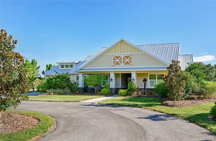 13120 Mulholland Road, Parrish, FL 34219  MLS # A4605565Front exterior of a classic country home, secluded 5 acre homesite with lush landscaping