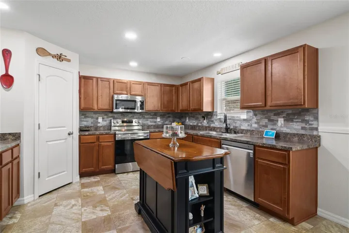 Kitchen with view of walk-in pantry.