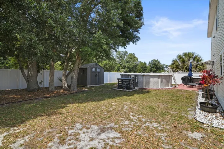 Large backyard with 18' saltwater pool, patio, and storage shed.
