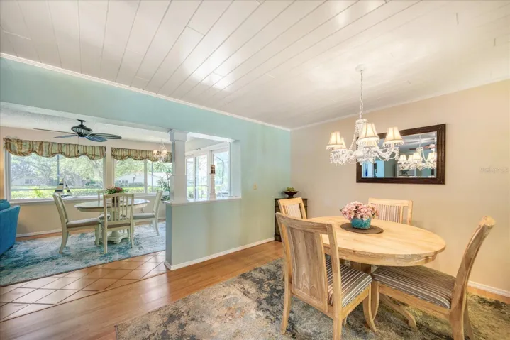 Wide opening with wood column definition leads to family room addition~