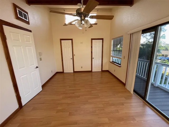 Primary bedroom with walk in closet and private balcony