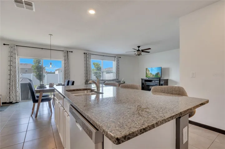 Kitchen with granite countertops and walk-in pantry. Open concept