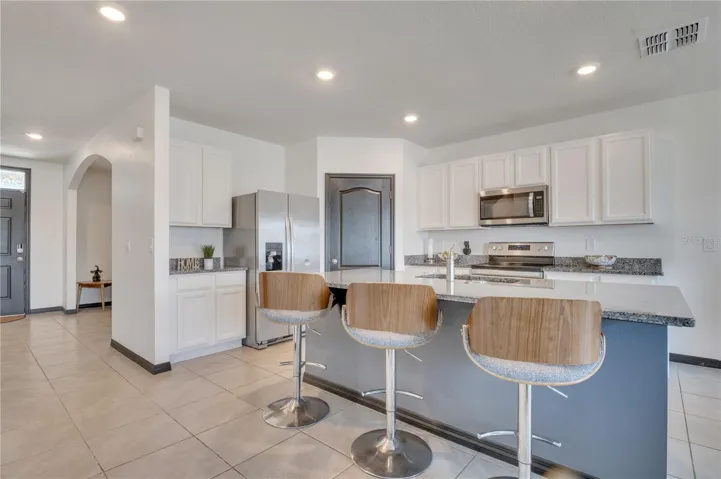 Kitchen with granite countertops and walk-in pantry.