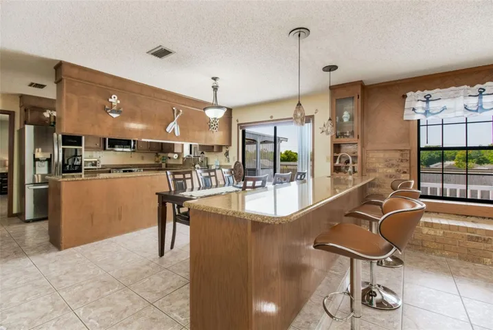 Granite counter eat-in bar top with built in wine rack and sink.