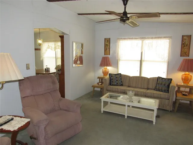 Living room with sliding glass door to raised Florida room.