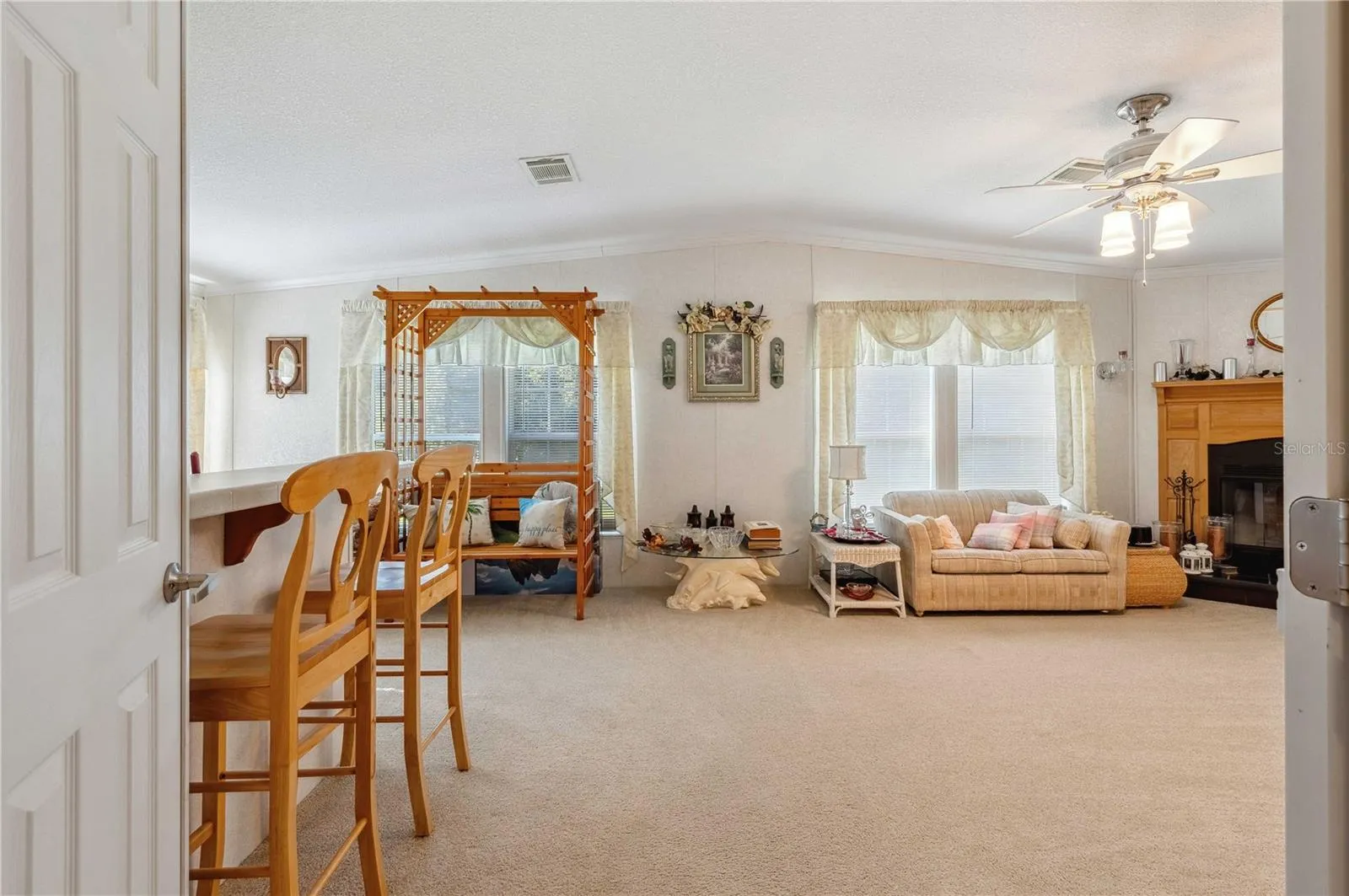 Family room is located at the back of this home with wood burning fireplace.