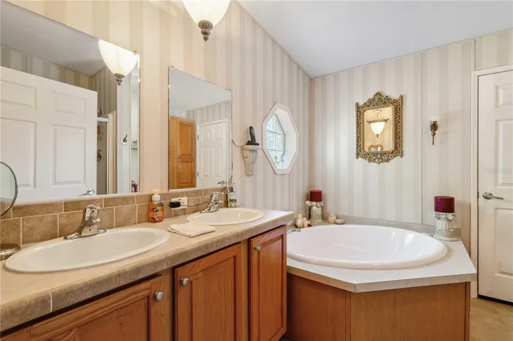 Primary retreat has step-in shower, double vanity, and tub.
