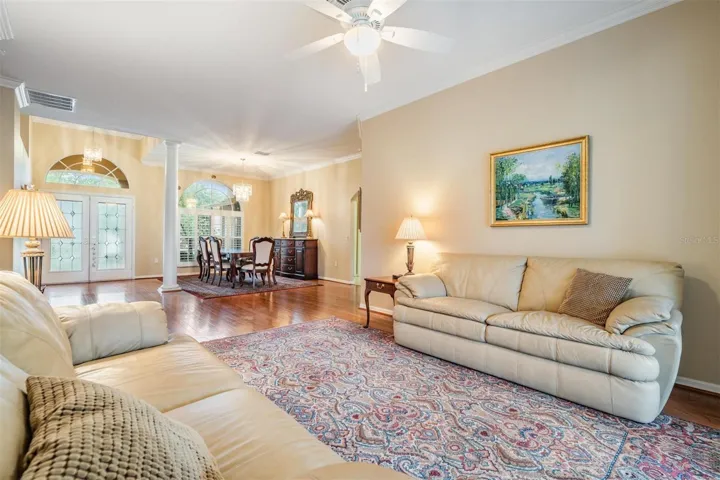 Living room with view of dining and entry foyer