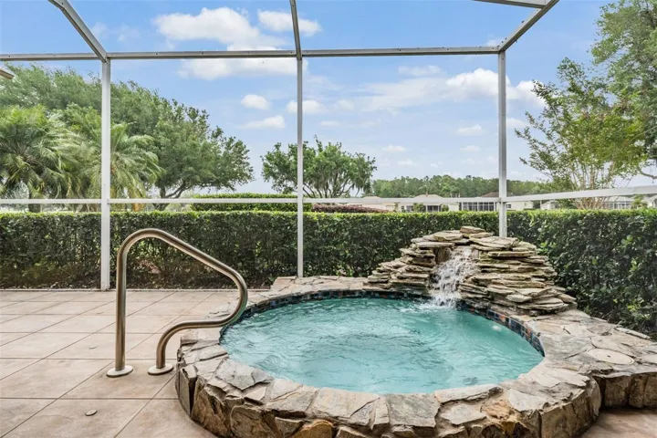 Private, custom spa with waterfall and greenway views