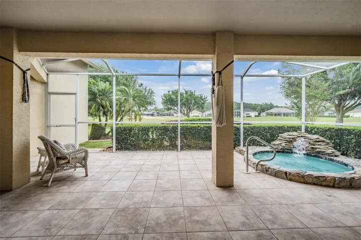 Covered area of lanai views the golf course and spa/waterfall
