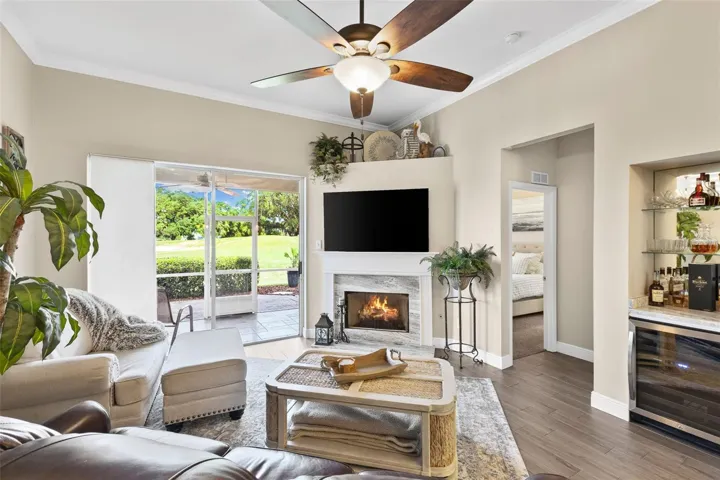 Open Living room with direct views of Fox Hallow golf course and hole 8..also includes a dry bar.