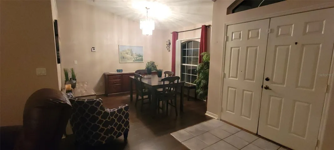 Looking at double entry front door from family room.  Dining room to right of door.