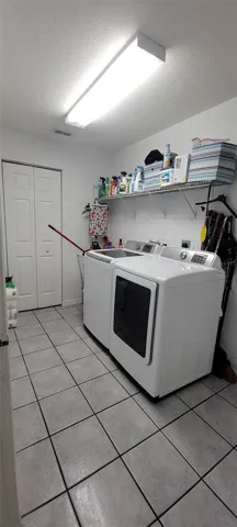 Inside Laundry room with storage closet