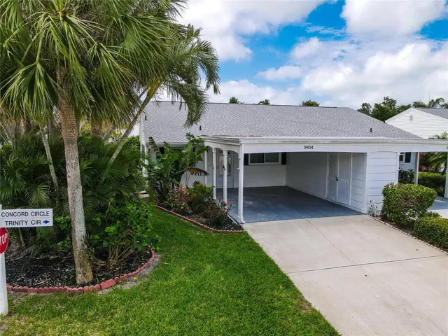 9404 Concord Circle. Oversized carport. Across from Canal. Tropical landscaping