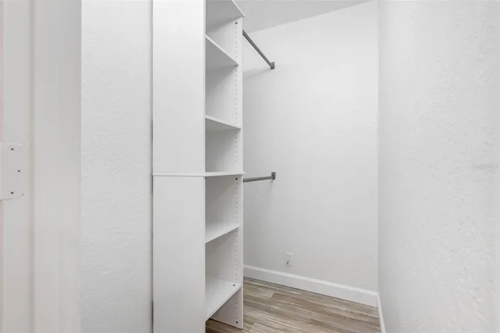 Primary BR walk in closet with custom organizers