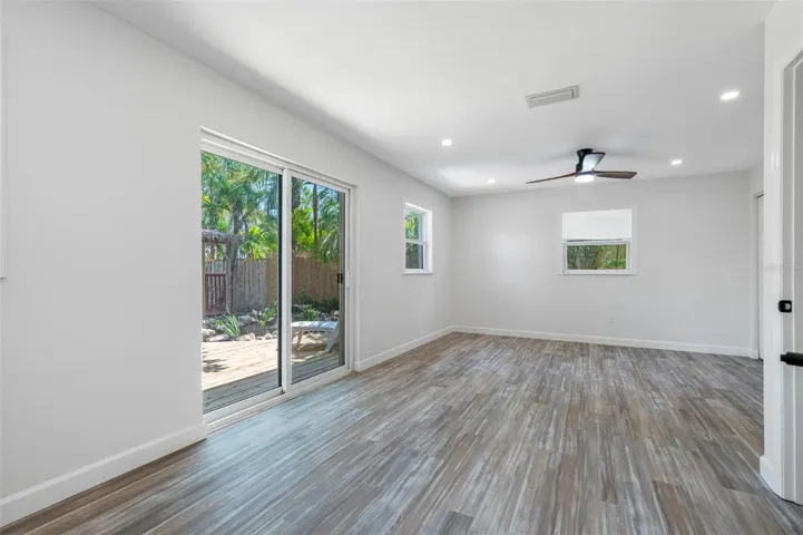 Primary bedroom with slider out to tropical garden