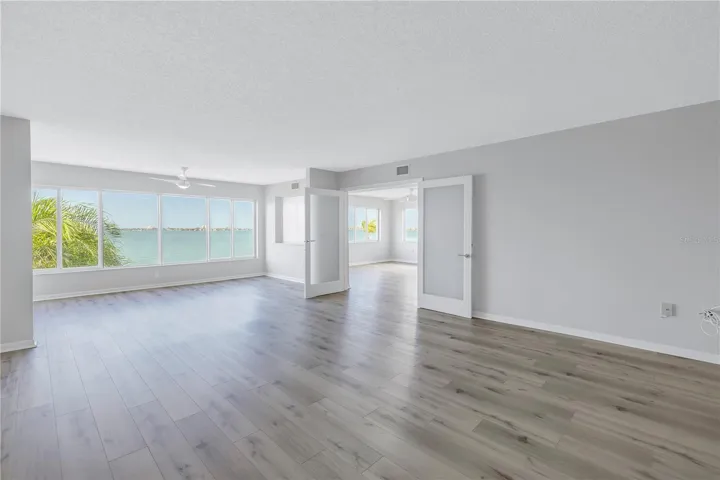Looking into primary bedroom with french doors with opaque glass
