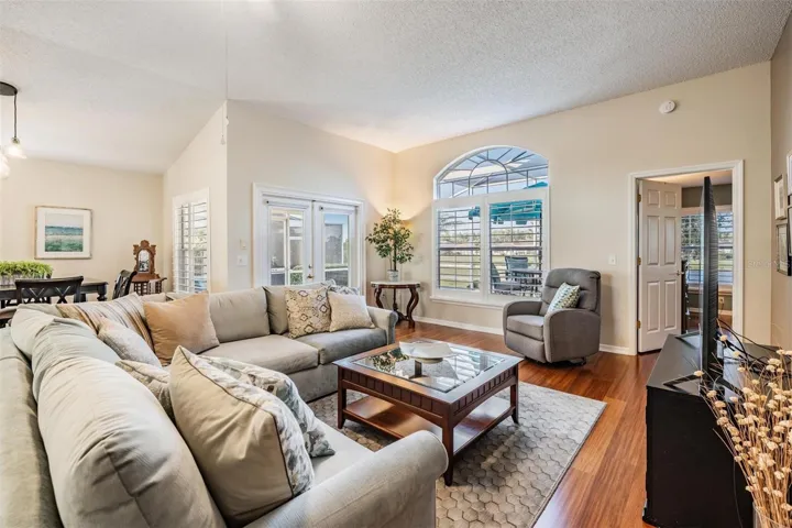 Bright and sunny family room with French doors to lanai