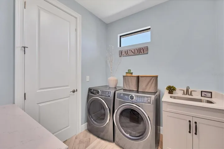 Laundry area connects to the primary bathroom and garage