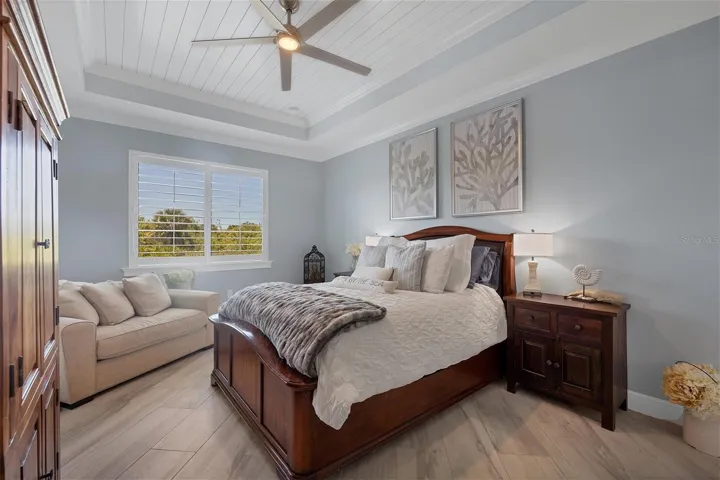 Primary Bedroom with gorgeous planked tray  ceiling